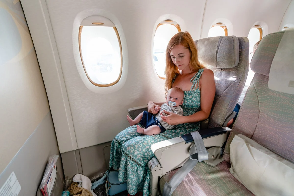 a baby enjoying flight with mother