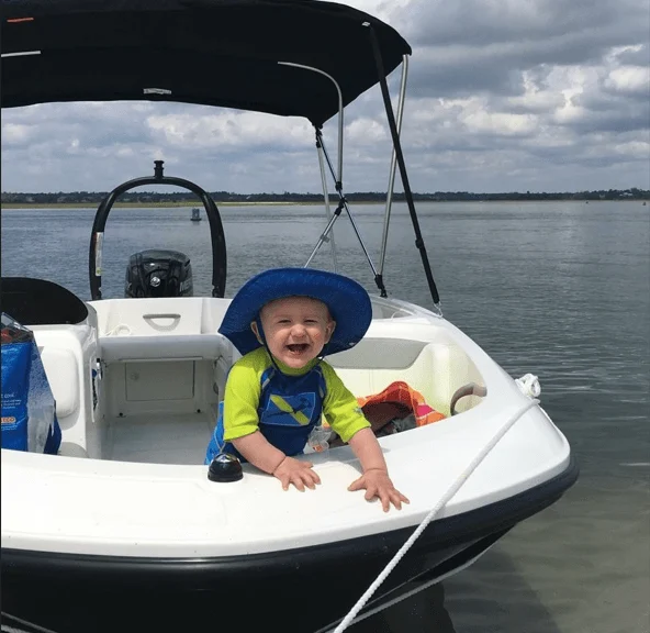 a toddler enjoying boar ride